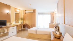 A hotel room with a bed, a desk, a television, and a bathroom. - Clef Hotel (Samut Prakan)