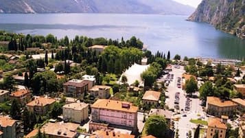 Vista aérea de un pueblo costero con edificios, un río y montañas al fondo.