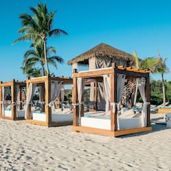 On the beach, white sand, sun-loungers, beach umbrellas