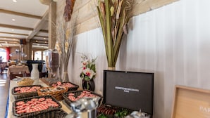 A buffet setup with various food items and a framed sign reading "Comptoirs Richard Paris".