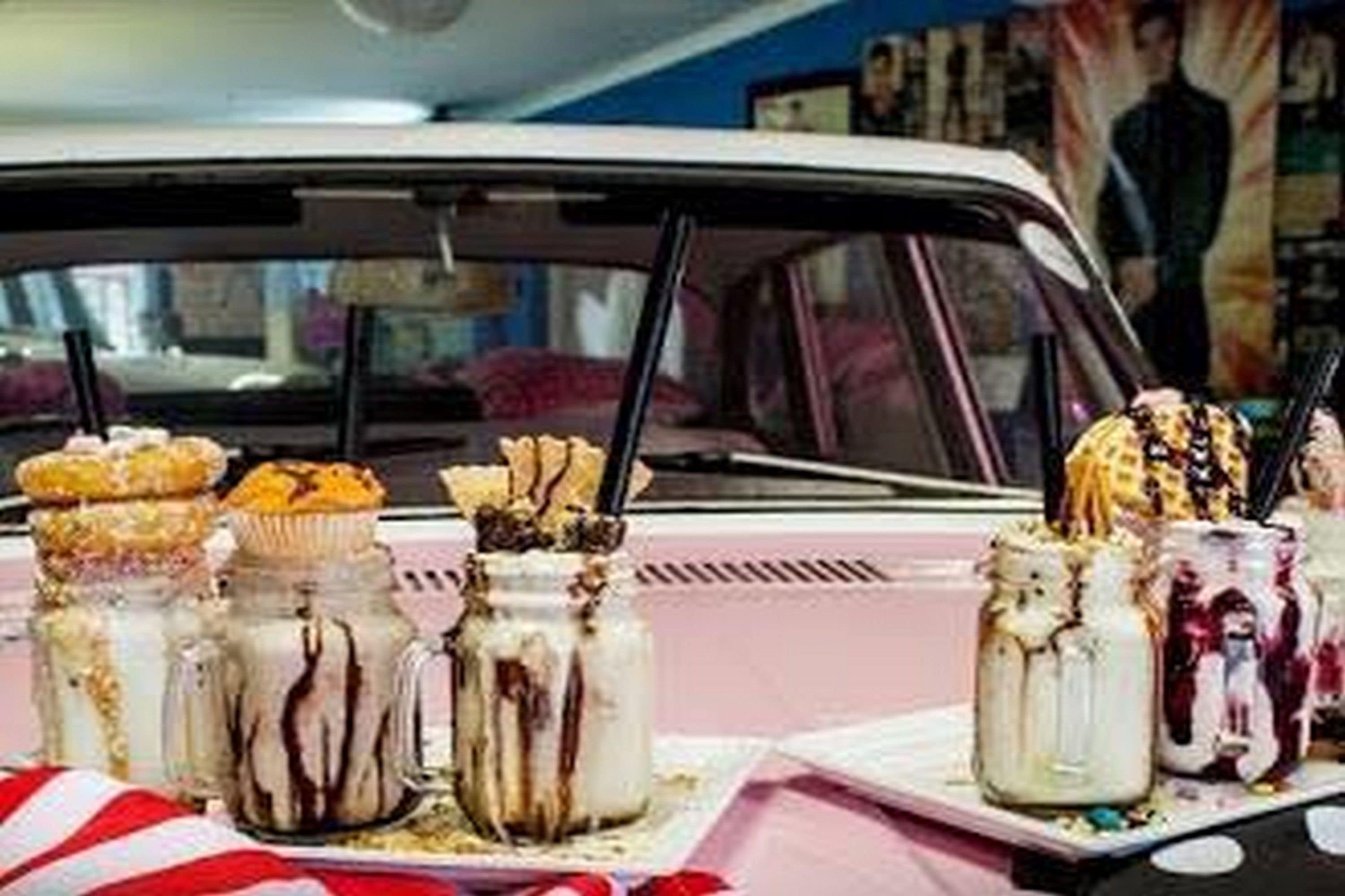 A car with a dessert display in the trunk.