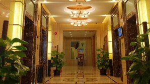 A hotel lobby with a marble floor, multiple chandeliers, and potted plants. - Howard Johnson Wyndham Leonora plzaz Shanghai (Shanghai)
