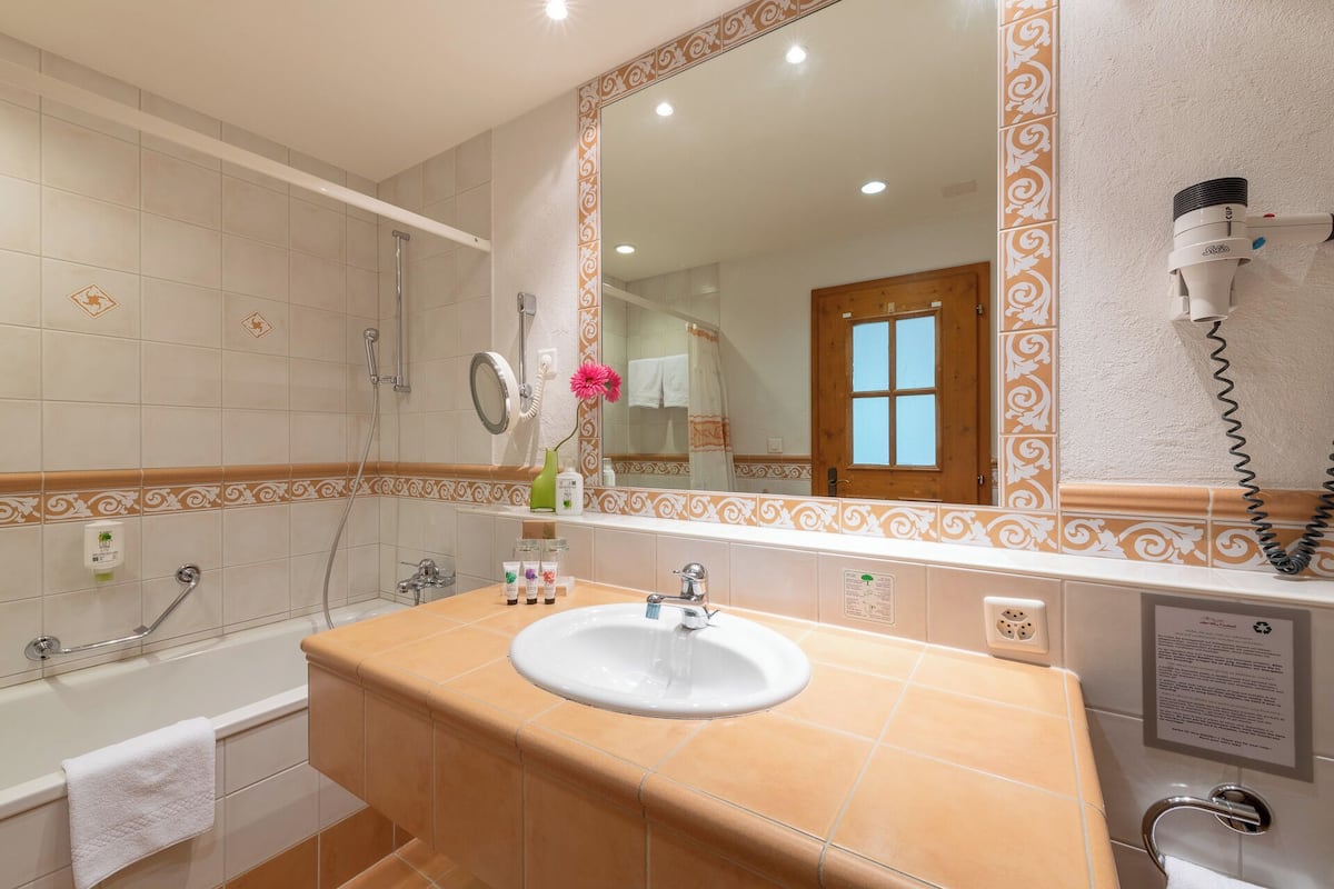 comfort double room (with separate sofa area) | bathroom | hair dryer, towels, soap, shampoo