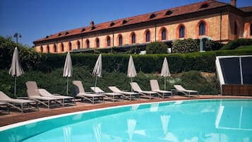 Seasonal outdoor pool, open 10:00 AM to 5:00 PM, pool umbrellas