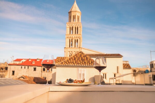 Enjoy a peaceful meal on the outdoor terrace with a view of the historic building.