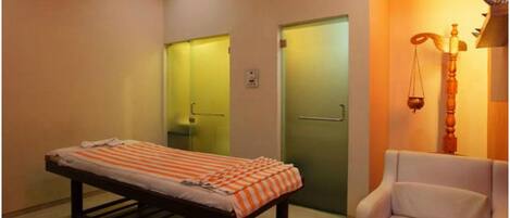 A room with a bed, a chair, and a scale.