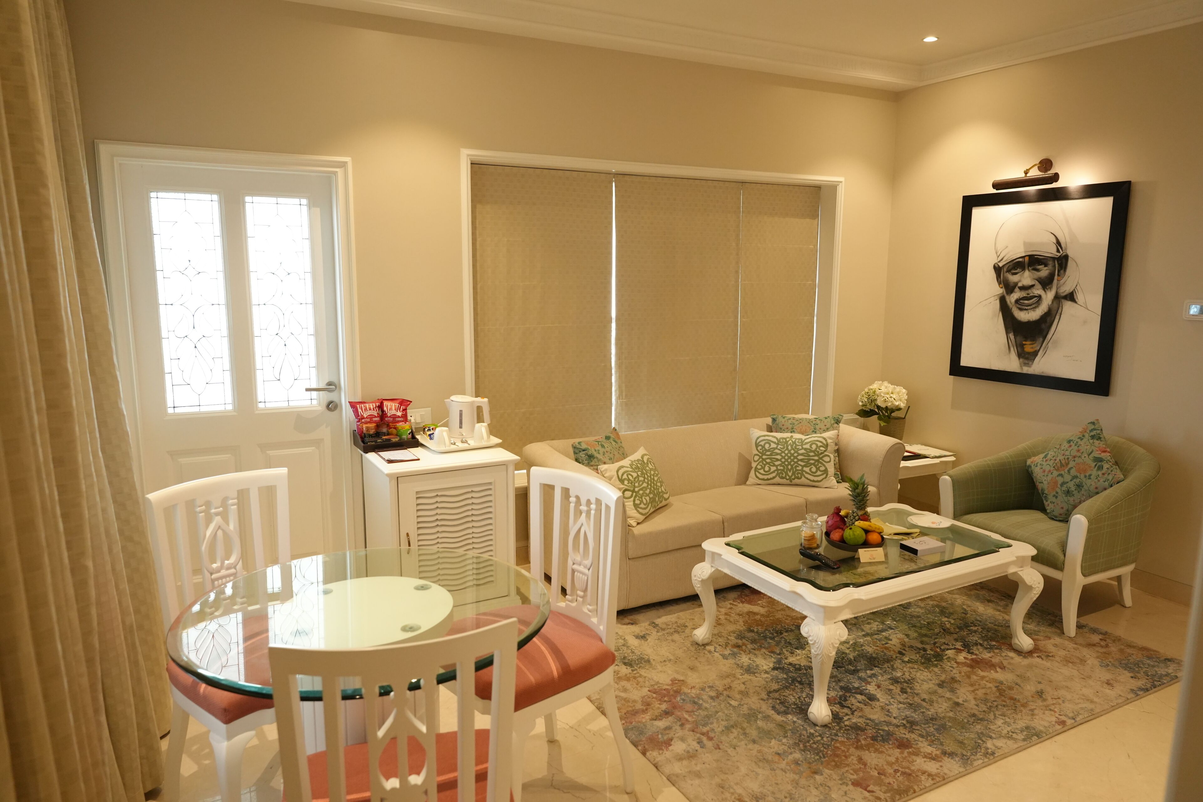 A living room with a sofa, chairs, a coffee table, and a dining table with chairs.