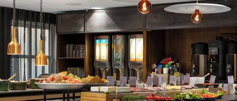 A buffet with various food items and beverage dispensers.