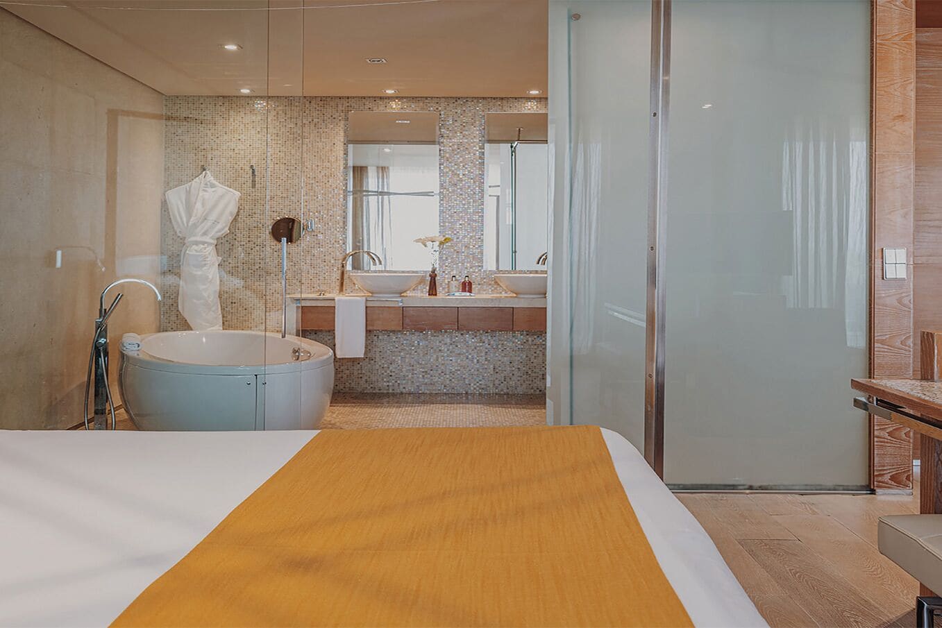 A modern bathroom with a freestanding bathtub, a large mirror, and a glass shower enclosure.