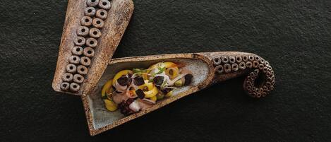 A rustic wooden spoon with a handle containing a salad.