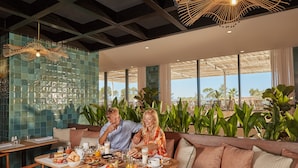 A breakfast setting with a table, breakfast items, and a view of the outdoors.