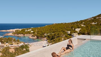 On the beach, white sand, sun loungers, beach umbrellas