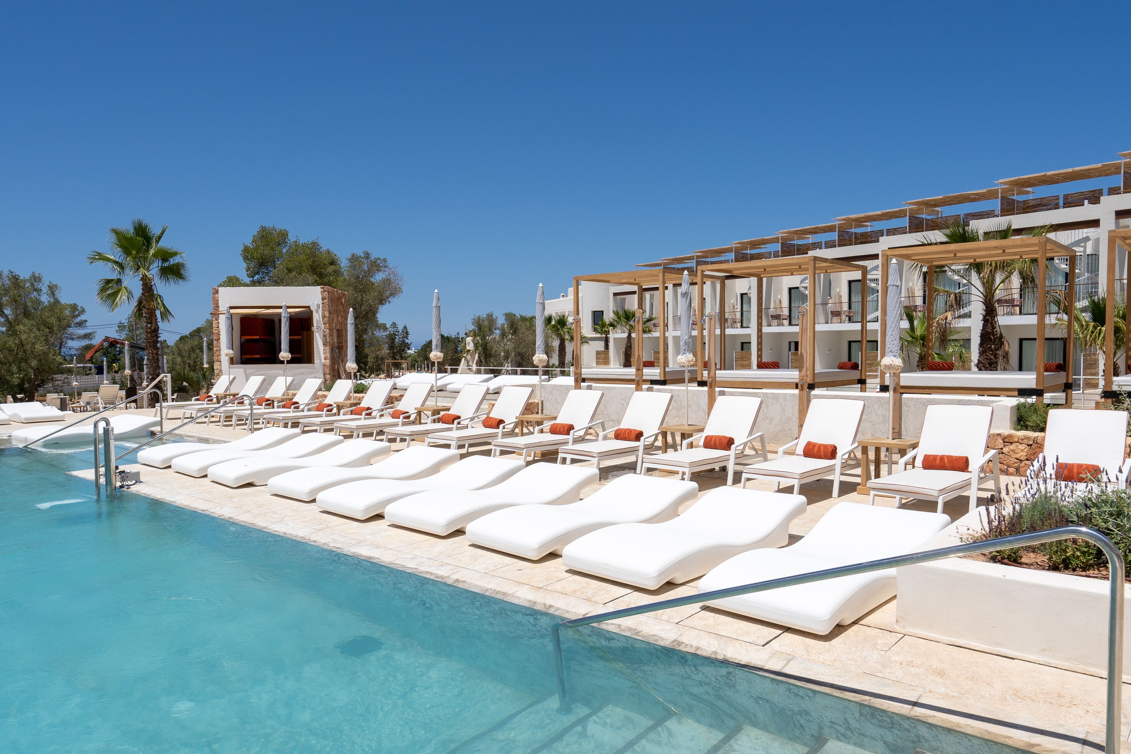 A poolside area with sun loungers and a pool.