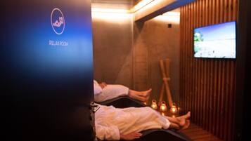 Experience relaxation in our serene RELAX ROOM, featuring a massage table and calming ambiance.