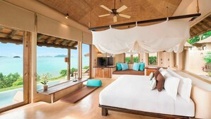 A spacious bedroom with a large bed, a TV, and a view of the sea. - The Naka Island, a Luxury Collection Resort & Spa, Phuket (Pa Klok)