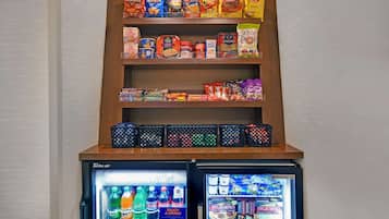 A snack and beverage display with various chips, cereals, and drinks.