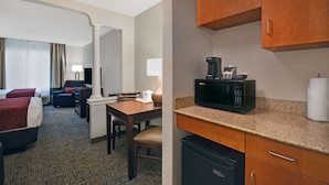 A hotel room with two beds, a desk, a chair, a microwave, and a refrigerator. - Comfort Inn & Suites Wilton (Wilton)