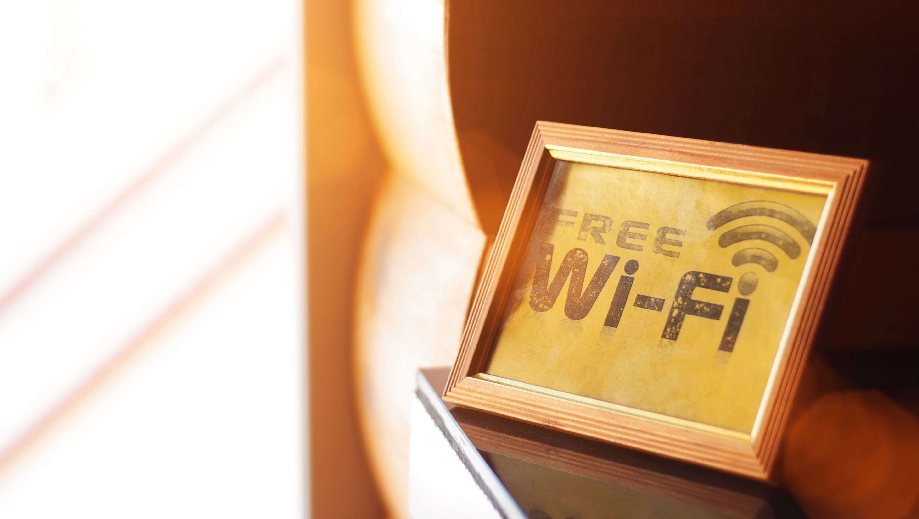A framed sign with "FREE Wi-Fi" and a Wi-Fi symbol.