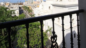 A white bell tower with a dome and cross, overlooking a cityscape with palm trees and buildings. - Gran Hotel Diligencias (Veracruz)
