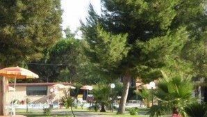 A resort area with outdoor seating, umbrellas, and a pool. - Villaggio Artemide (Giardini Naxos)