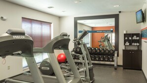 A gym with treadmills, a red exercise ball, and a wall-mounted TV. - Hampton Inn Goshen (Goshen)