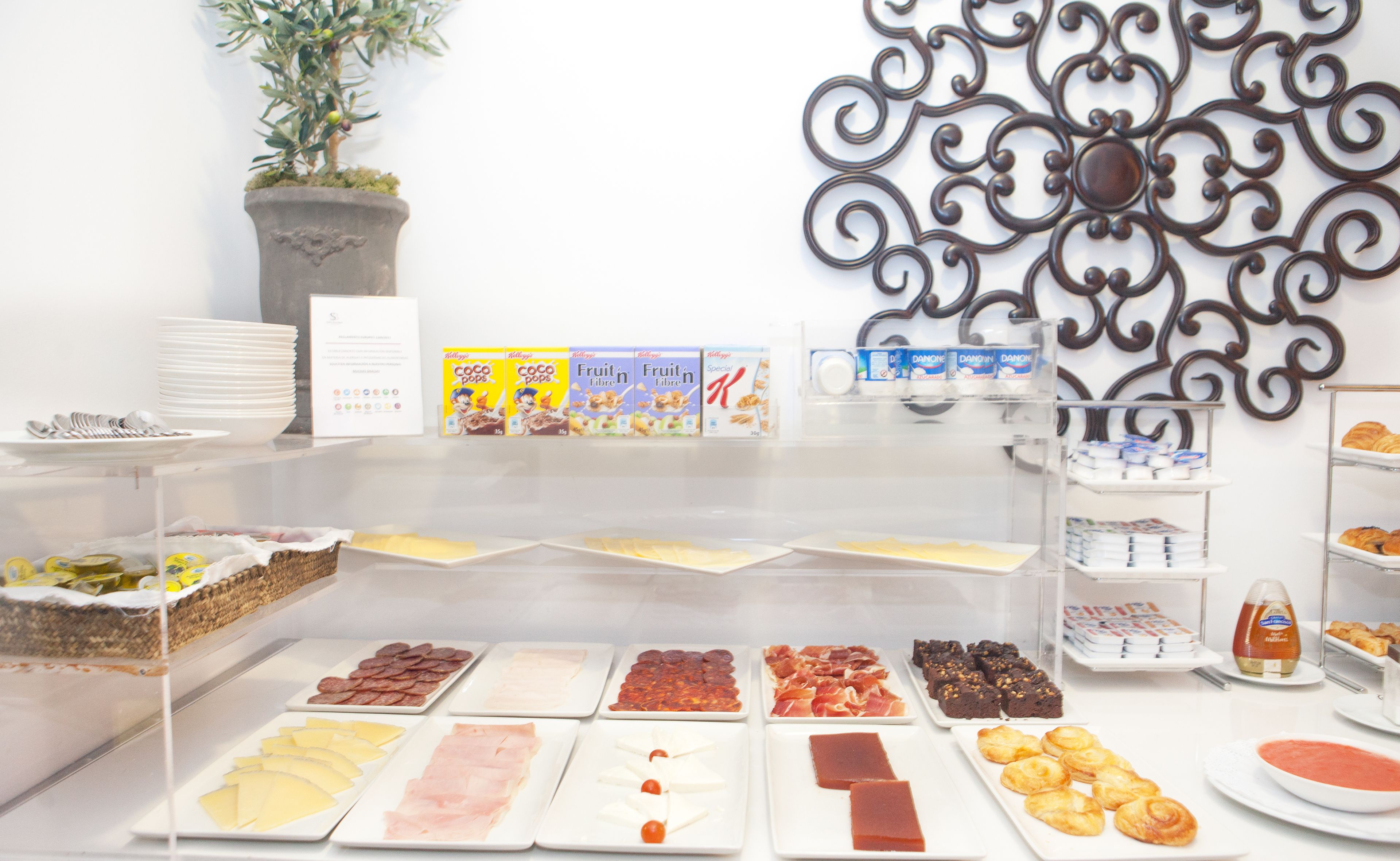 A breakfast buffet with various food items and beverages.