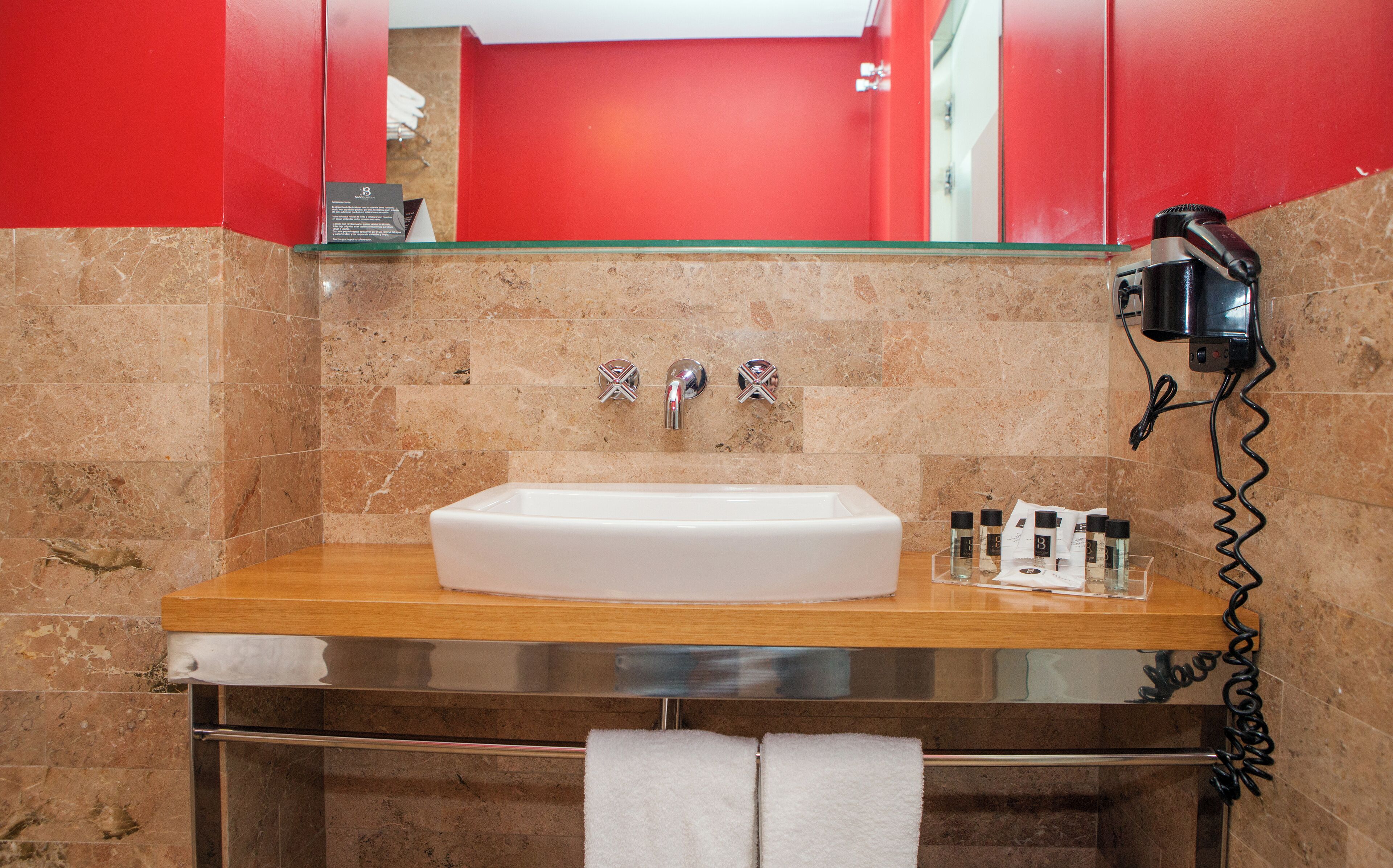 hair dryer, towels, shampoo, toilet paper