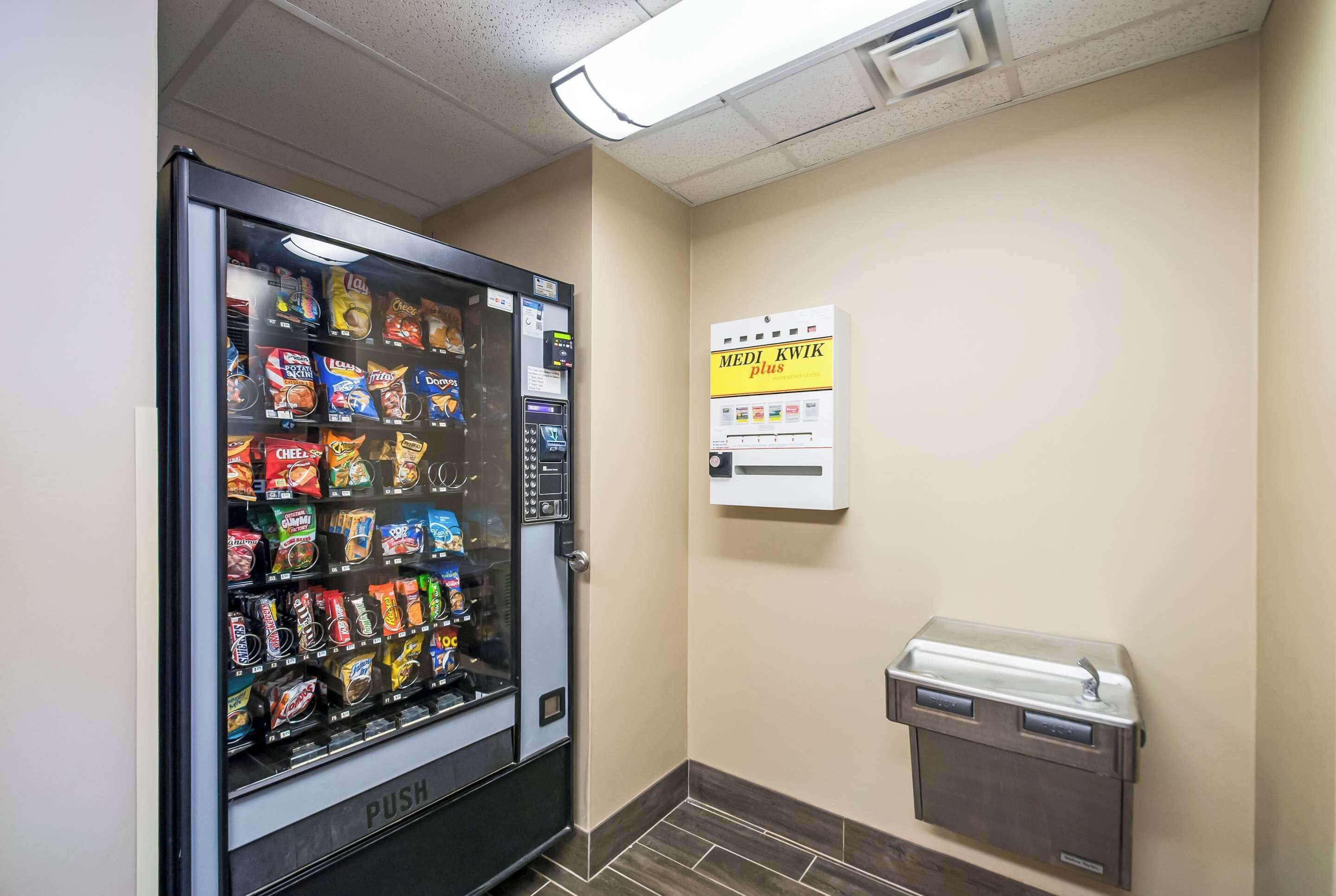 A vending machine with various snacks and a water dispenser.