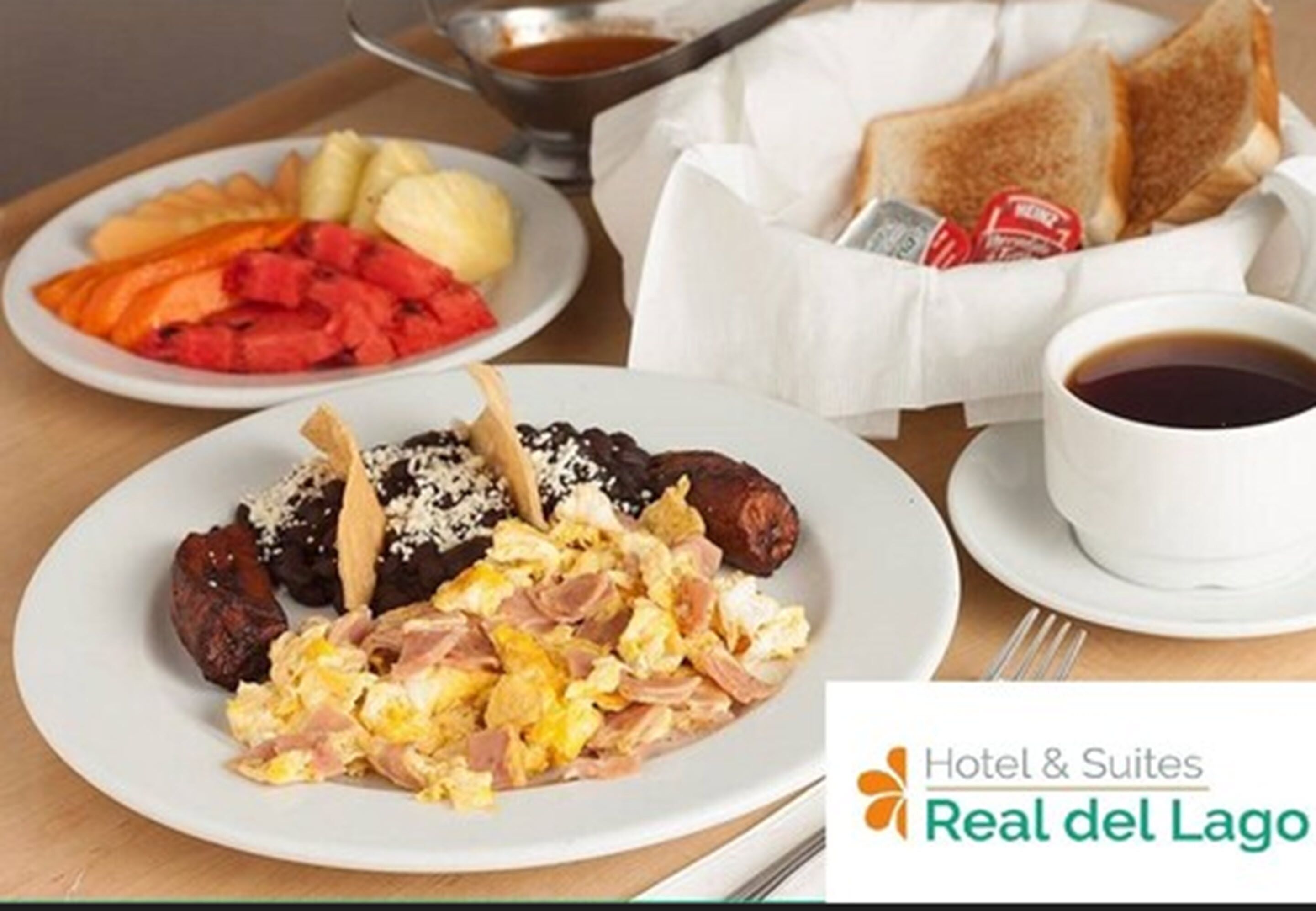 A breakfast setting with plates of food, toast, and a cup of coffee.