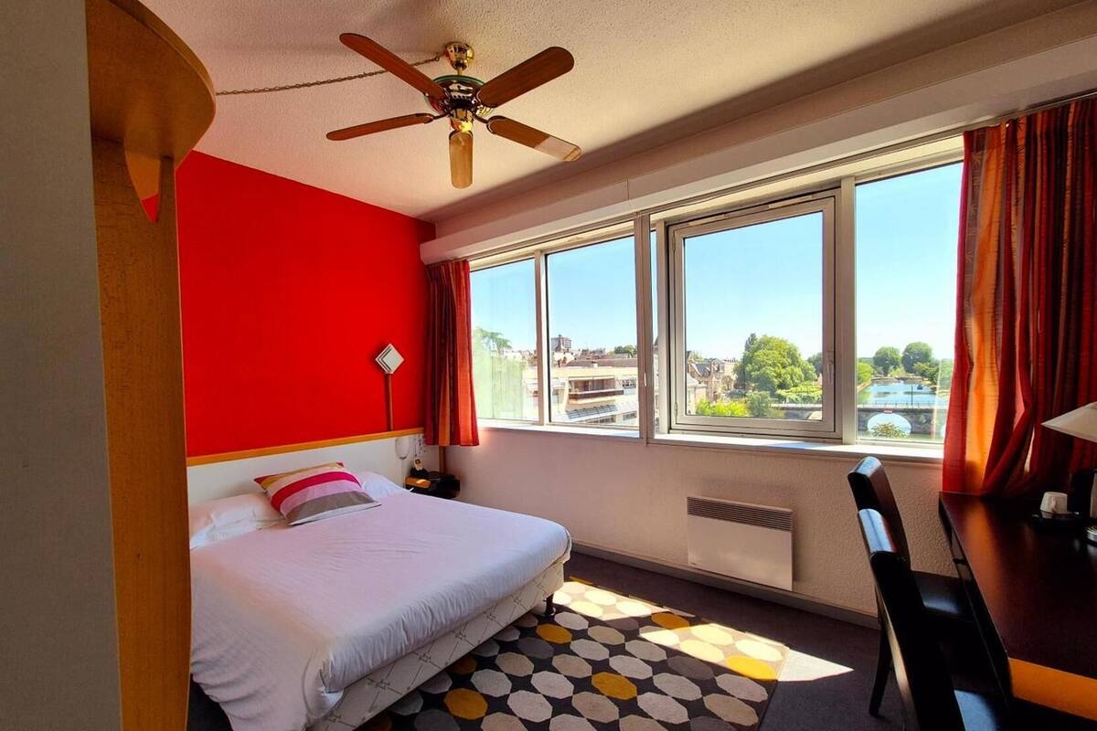 Premium bedding, desk, laptop workspace, blackout drapes