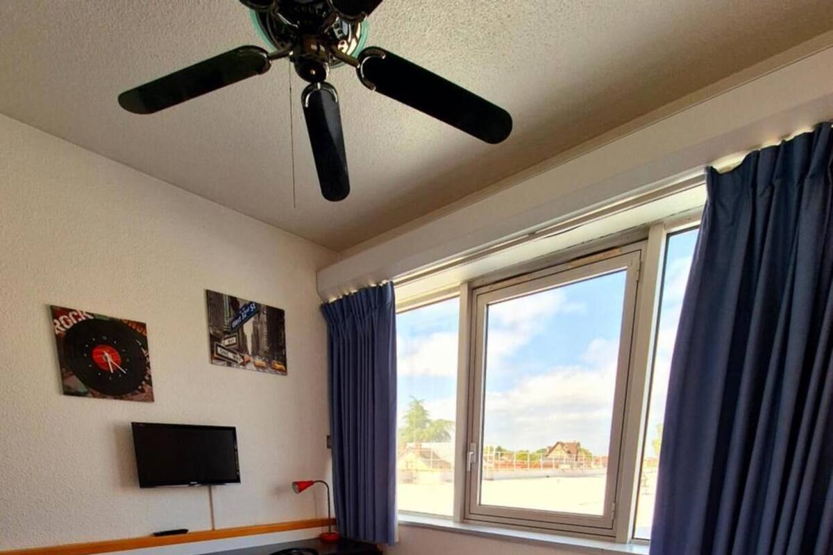 Premium bedding, desk, laptop workspace, blackout drapes