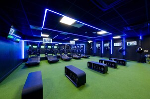 A gym with treadmills, weight machines, and benches.