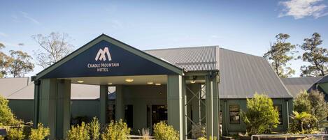 A building with a sign reading "Cradle Mountain Hotel."