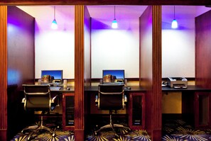 A conference room with three desks, each equipped with a computer, chair, and telephone. - Holiday Inn Express Hotel & Suites Brooksville by IHG (Brooksville)