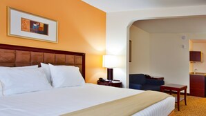 A hotel room with a large bed, a desk, a chair, and a small kitchenette. - Holiday Inn Express Hotel & Suites Brooksville by IHG (Brooksville)