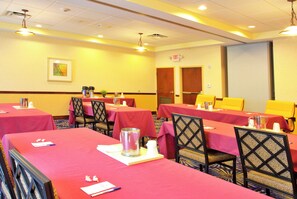 A conference room with tables set for meetings, equipped with nameplates, pens, and water pitchers. - Holiday Inn Express Hotel & Suites Brooksville by IHG (Brooksville)