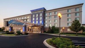 A DoubleTree by Hilton hotel with a modern design, a covered entrance, and well-maintained landscaping. - DoubleTree by Hilton Chicago Midway Airport (Chicago)