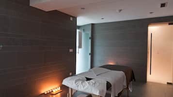 Cozy retreat with a single bed, bedside table, and wall-mounted shelf, set against a backdrop of dark tiles and a large window.