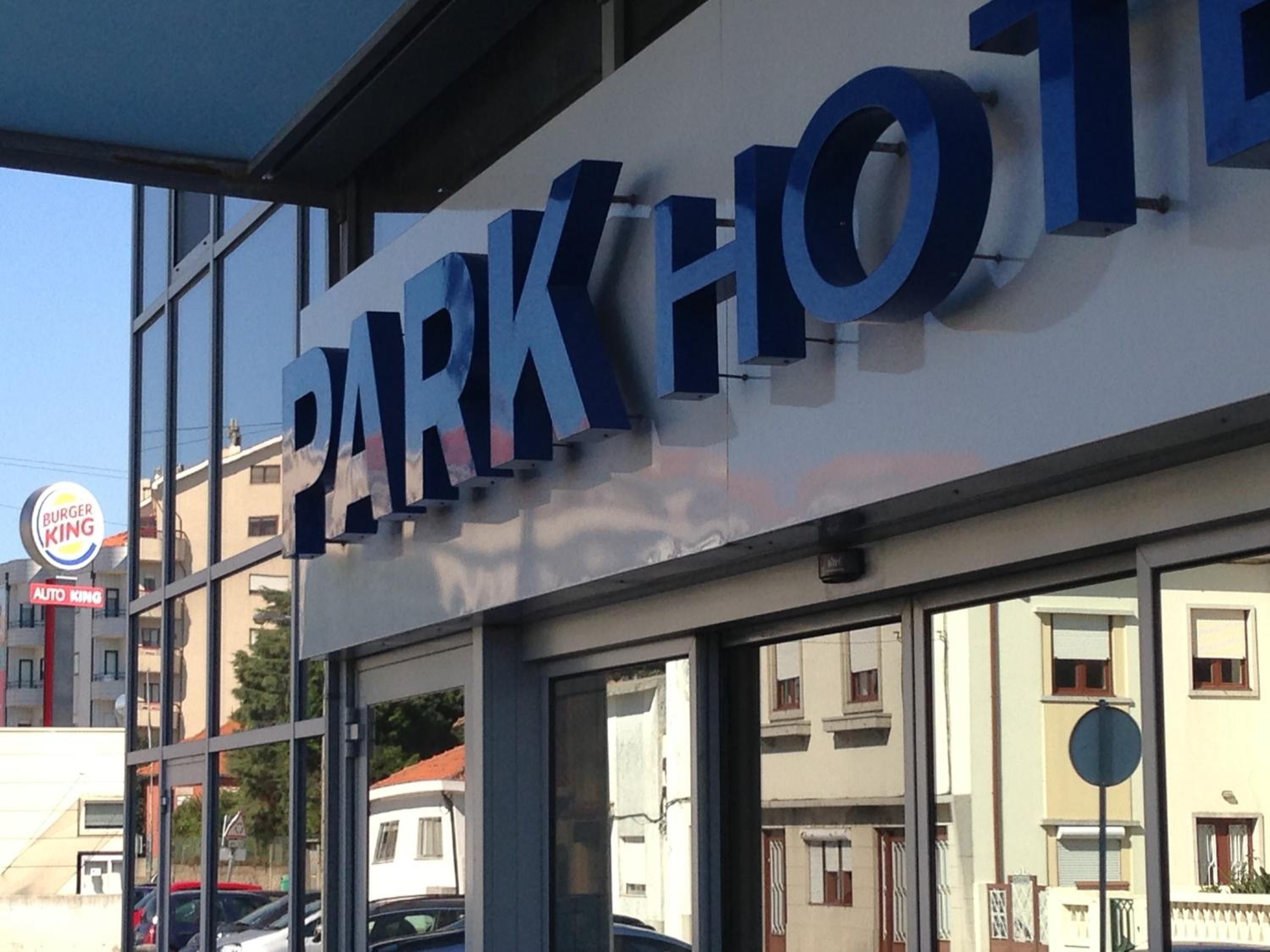 A building with a sign that reads 'PARK HOTEL'.