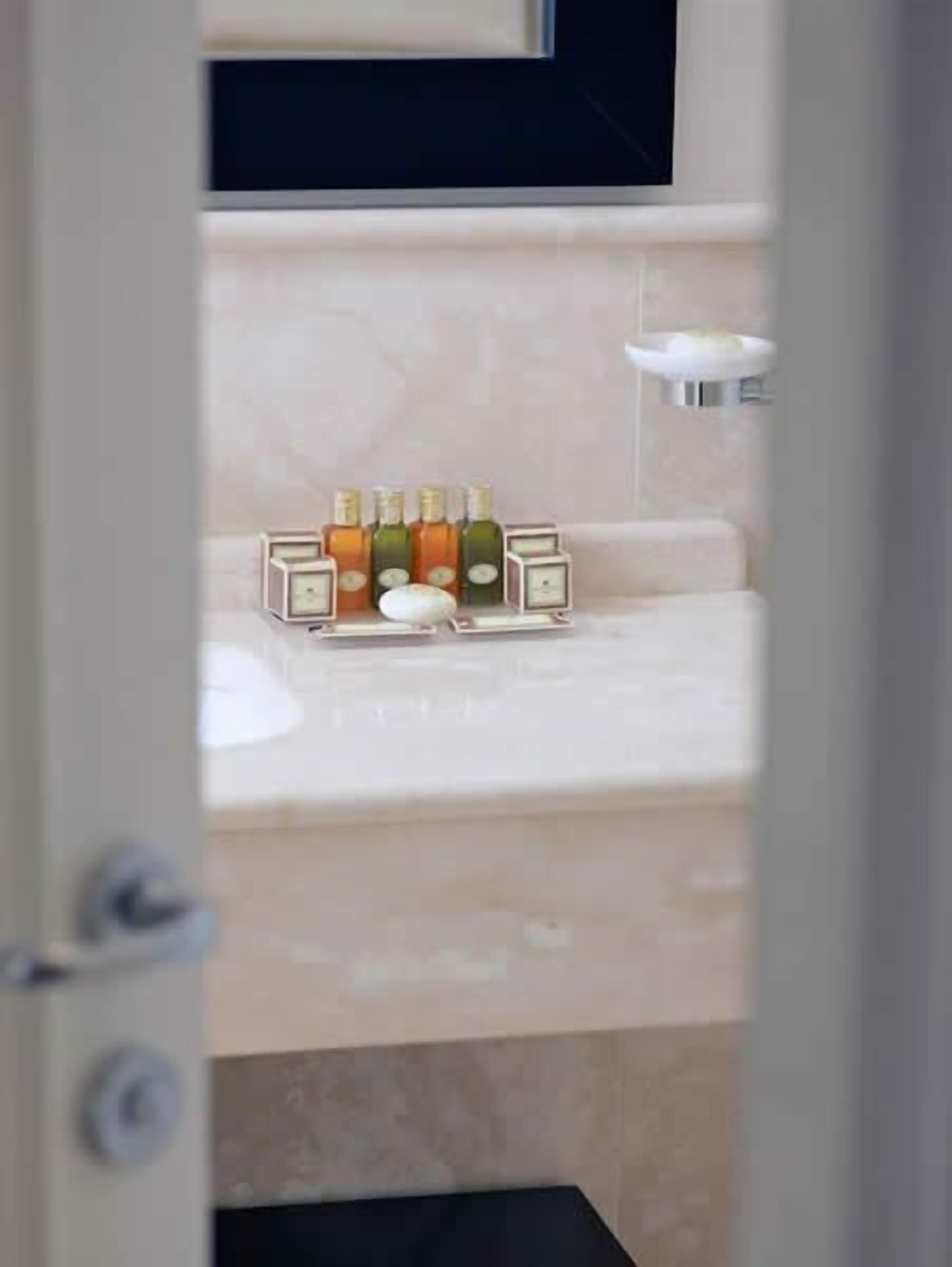 rainfall showerhead, designer toiletries, hair dryer, slippers