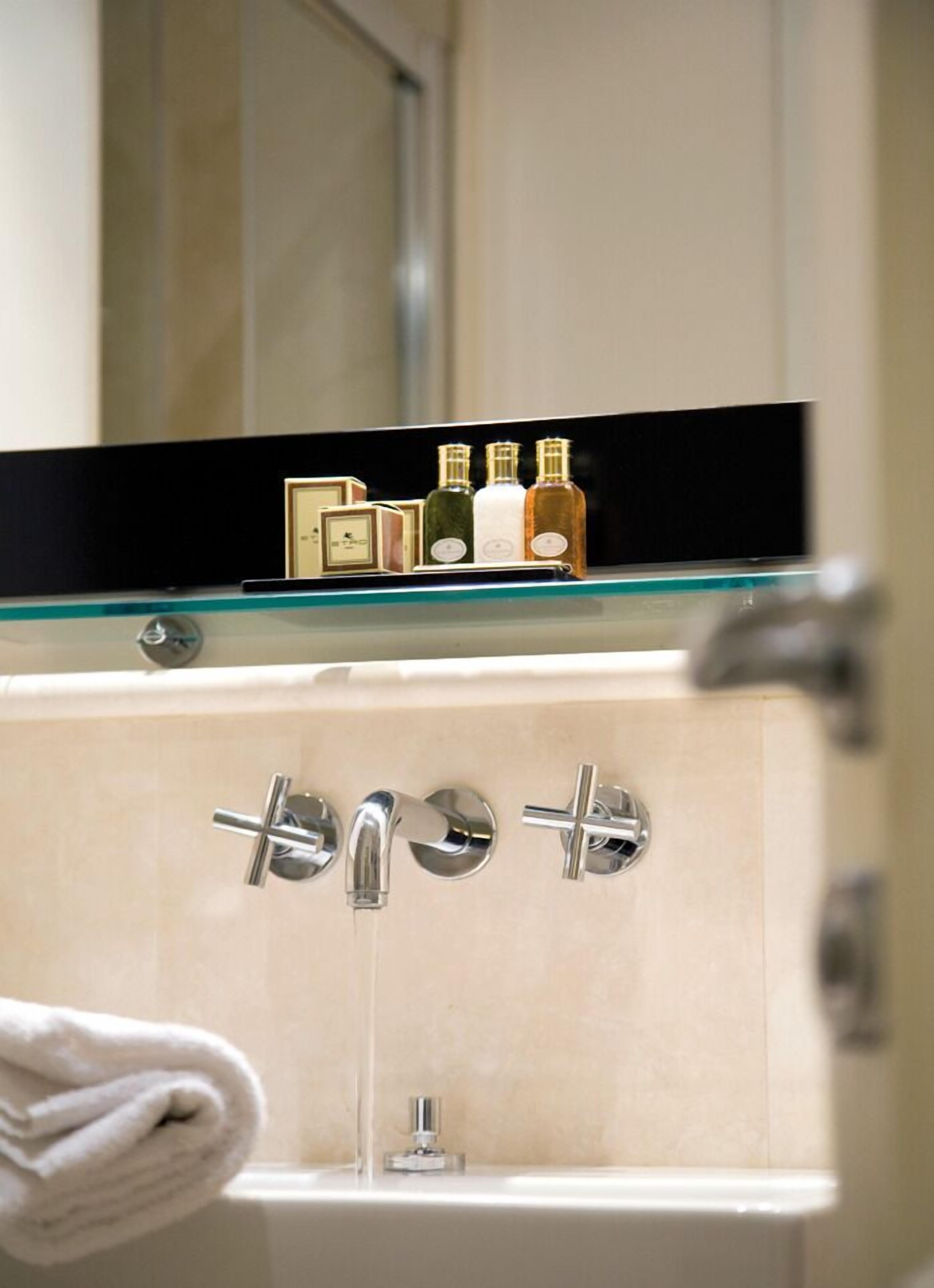 rainfall showerhead, designer toiletries, hair dryer, slippers