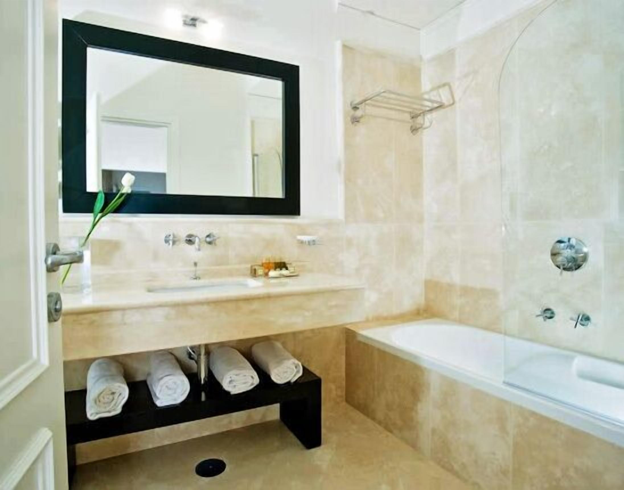 suite junior | bathroom | rainfall showerhead, designer toiletries, hair dryer, slippers