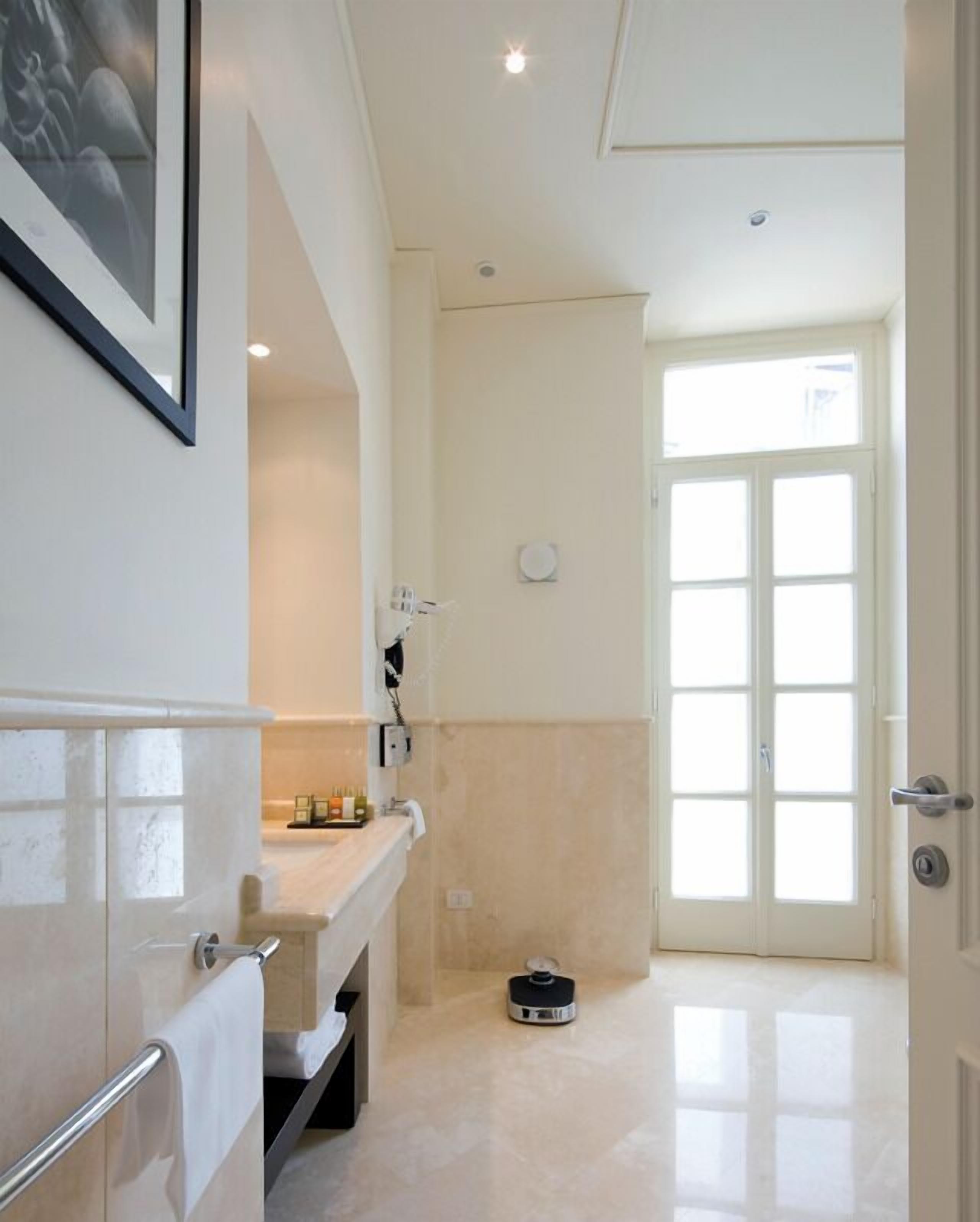 deluxe double or twin room | bathroom | rainfall showerhead, designer toiletries, hair dryer, slippers