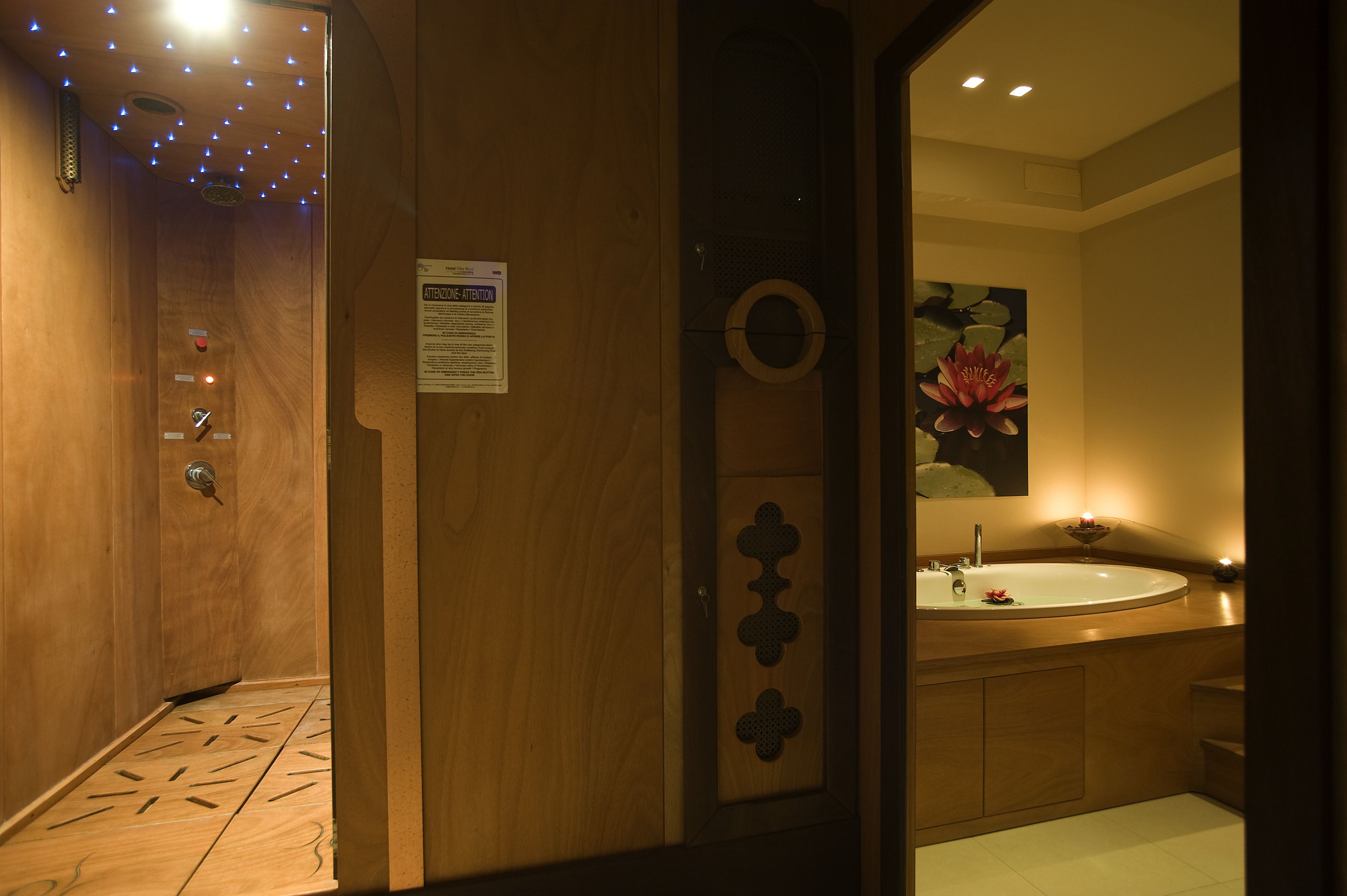 A wooden bathroom with a sink, mirror, and a lotus flower painting.