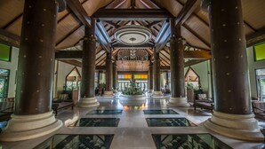A spacious lobby with high wooden beams, large columns, and a central chandelier. - Chada Lanta Beach Resort  (Ko Lanta)