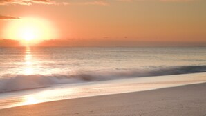 A beach at sunset with the sun reflecting on the water. - Port d'Hiver (Melbourne Beach)