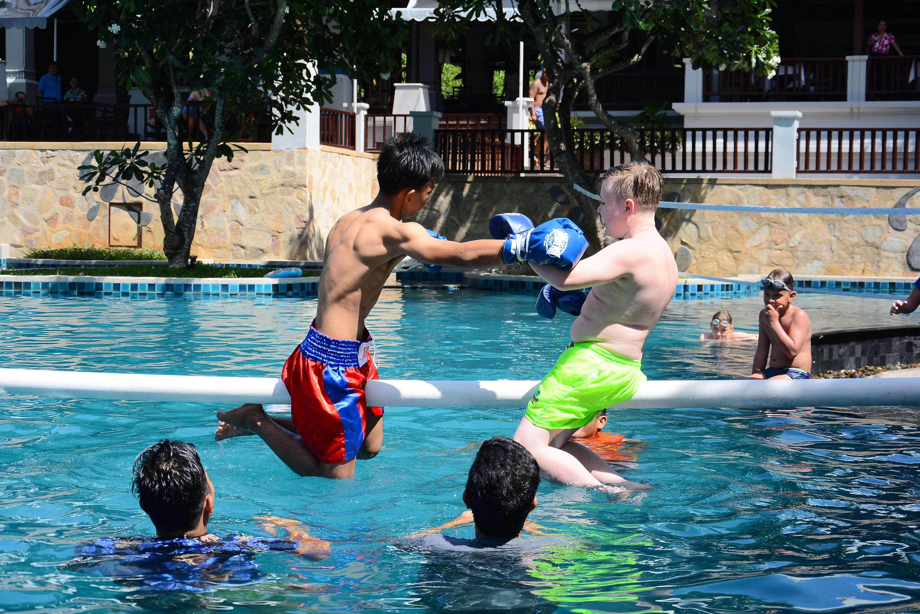 A swimming pool with people engaging in water activities.