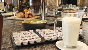 A breakfast buffet with various food items and containers. - Airport Hotel Budapest (Vecsés)