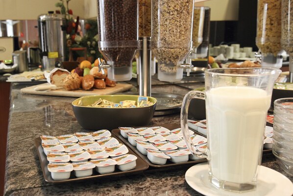 A breakfast buffet with various food items and containers.