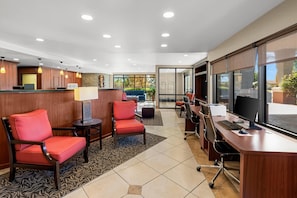 A hotel reception area with a desk, chairs, and a large window. - Comfort Suites Vacaville-Napa Valley Area (Vacaville)